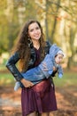 Funny baby in the arms of mother. Attractive young woman mother with her son in her arms. Portrait of a happy mother and baby Royalty Free Stock Photo