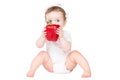 Funny baby biting on a big red paprika