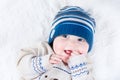 Funny baby in blue knitted hat and warm sweater