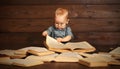 Funny baby with books in glasses