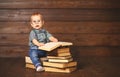 Funny baby with books in glasses Royalty Free Stock Photo