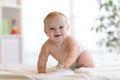 Funny baby boy crawling on bed at home Royalty Free Stock Photo