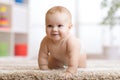 Funny baby boy crawling on floor at home Royalty Free Stock Photo