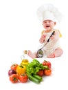 Funny baby boy preparing healthy food