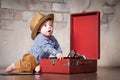 Funny baby boy in retro hat with vinyl record and gramophone Royalty Free Stock Photo