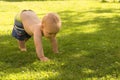 Funny baby boy toddle outdoor on the lawn