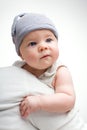 Funny baby in a cap on a light background. Handsome little boy with blue eyes Royalty Free Stock Photo