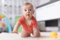 Funny baby crawling on the floor in nursery room Royalty Free Stock Photo