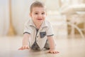 Funny baby crawls on the floor and laughs Royalty Free Stock Photo