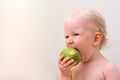 Funny baby eating apple