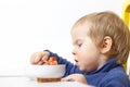 Funny Baby eats vegetable soup spoon Royalty Free Stock Photo