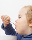 Funny Baby eats vegetable soup spoon Royalty Free Stock Photo