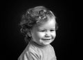 Funny baby face close up. Smiling infant, cute smile. Kids head portrait. Isolated on black studio. Royalty Free Stock Photo