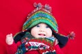 Funny baby girl in colorful knitted hat and scarf Royalty Free Stock Photo