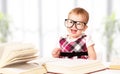 Funny baby girl in glasses reading a book Royalty Free Stock Photo