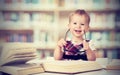 Funny baby girl in glasses reading a book Royalty Free Stock Photo