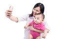 Funny baby girl looking at the camera and smiling, make selfie on mobile phone Royalty Free Stock Photo