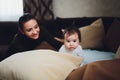 Funny baby girl with mother at home. Royalty Free Stock Photo