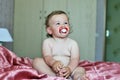 Funny baby girl with soother Royalty Free Stock Photo