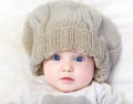 Funny baby in a huge knitted hat Royalty Free Stock Photo