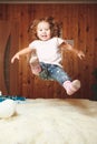 Funny baby jumping on the bed.