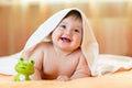 Funny baby kid under a hooded towel after bath