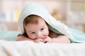 Funny baby kid under a hooded towel after bath