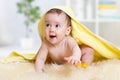 Funny baby kid under a hooded towel after bath