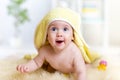 Funny baby kid under a hooded towel after bath