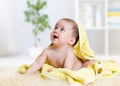 Funny baby kid under a hooded towel after bath