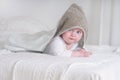 Funny baby kid under a hooded towel