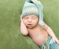 Funny baby in knitted hat sleeping with opened mouth Royalty Free Stock Photo