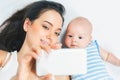 Funny baby and mother make selfie on mobile phone Royalty Free Stock Photo