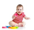 Funny baby playing with toys while sitting on floor, Royalty Free Stock Photo