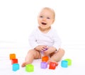 Funny baby sitting playing with colorful toys