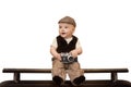 The funny baby traveler with a retro camera