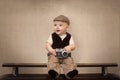 The funny baby traveler with a retro camera