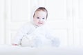 Funny baby wearing a teddy bear snow suit Royalty Free Stock Photo