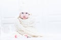 Funny baby wearing a warm knitted scarf and hat Royalty Free Stock Photo