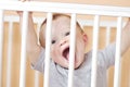 Funny baby in white bed Royalty Free Stock Photo