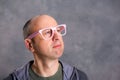 Funny baldheaded man with pink glasses