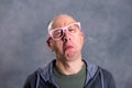 Funny baldheaded man with pink glasses