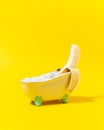 Funny banana relaxing in the bathtub. Holiday concept idea