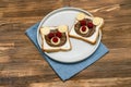 Funny bear face sandwich toast bread with peanut butter, cheese and raspberry on plate napkin wooden background. Kids child sweet Royalty Free Stock Photo