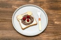 Funny bear face sandwich toast bread with peanut butter, cheese and raspberry on plate wooden background close up. Kids Royalty Free Stock Photo