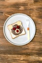 Funny bear face sandwich toast bread with peanut butter, cheese and raspberry on plate wooden background close up. Kids child Royalty Free Stock Photo