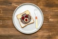 Funny bear face sandwich toast bread with peanut butter, cheese and raspberry on plate wooden background close up. Kids child Royalty Free Stock Photo