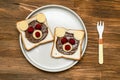 Funny bear face sandwich toast bread with peanut butter, cheese and raspberry on plate wooden background. Kids child Royalty Free Stock Photo