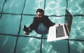 Funny bearded business man in suit using phone and laptop in swimming pool. Concept of young people working mobile Royalty Free Stock Photo