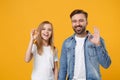 Funny bearded man in casual clothes have fun with child baby girl. Father, little kid daughter isolated on yellow orange Royalty Free Stock Photo